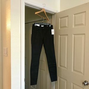 Ladies mid rise skinny black stretchy pant .